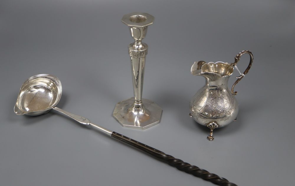 A Victorian engraved silver cream jug, Richards & Brown, London, 1869, toddy ladle and candlestick.